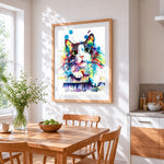 Vibrant watercolour splash cat cross stitch artwork displayed on wall as home decor