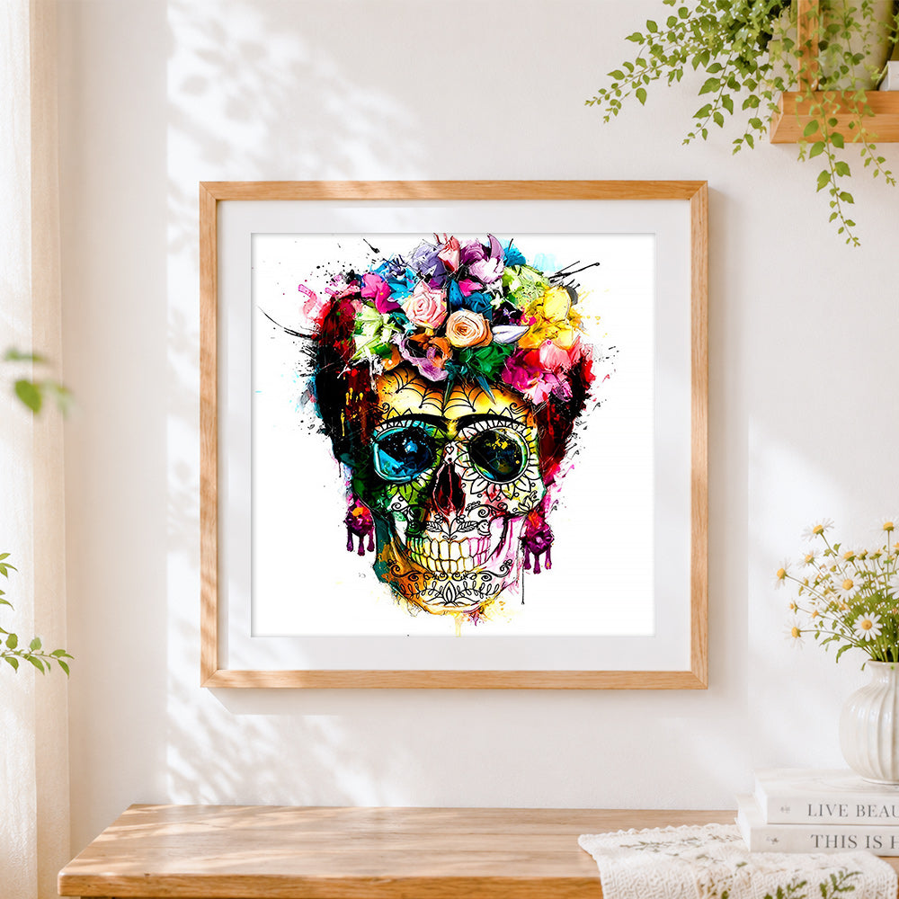 Finished vibrant watercolour splatter sugar skull cross stitch artwork displayed