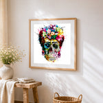 Vibrant watercolour splatter sugar skull cross stitch artwork displayed on wall as home decor