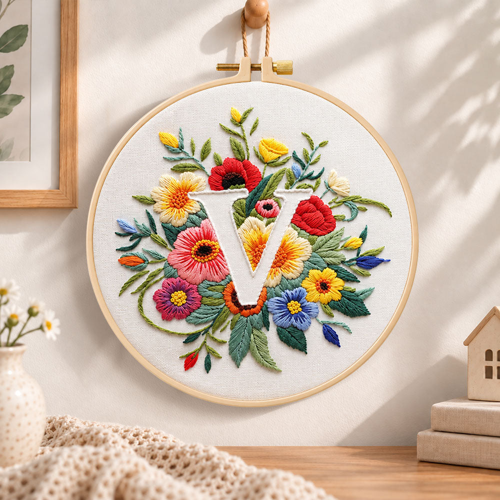Vibrant wildflowers and letter v embroidery hoop wall art displayed as warm and cosy handmade home decor