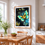 Vibrant yellow and green butterflies cross stitch artwork displayed on wall as home decor