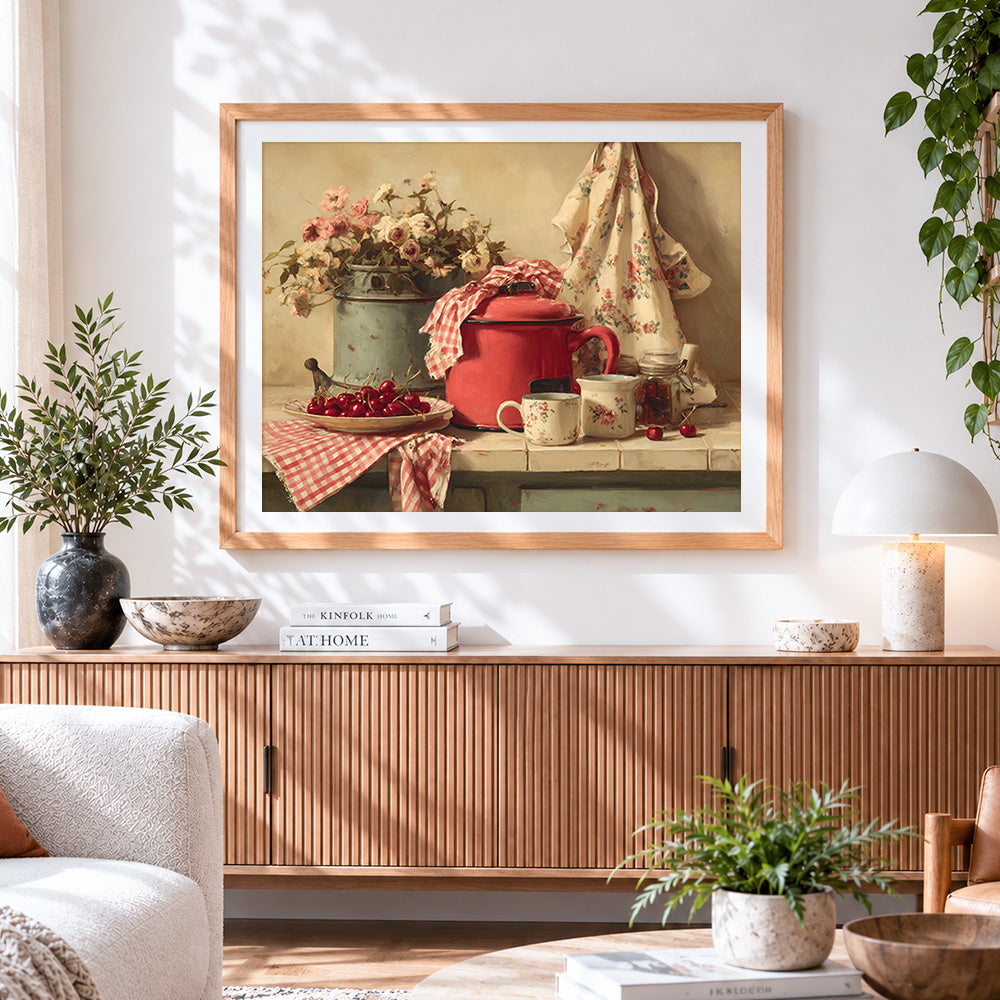 Finished vintage red enamel pot and cherries cross stitch artwork displayed