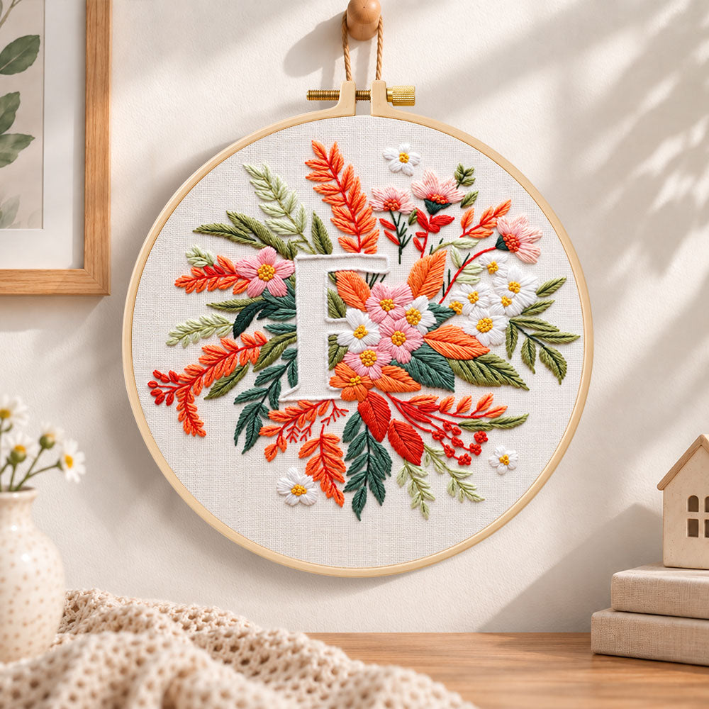 Warm autumn foliage and letter f embroidery hoop wall art displayed as warm and cosy handmade home decor
