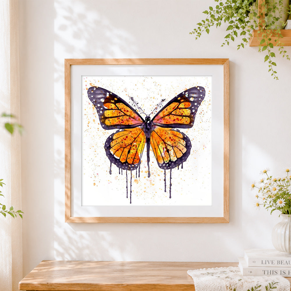 Finished watercolour butterfly with splatter effect cross stitch artwork displayed