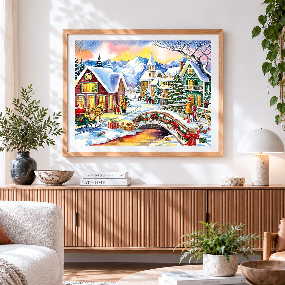 Finished watercolour christmas village with bridge cross stitch artwork displayed