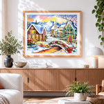Finished watercolour christmas village with bridge cross stitch artwork displayed