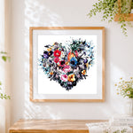 Finished watercolour floral heart skulls cross stitch artwork displayed