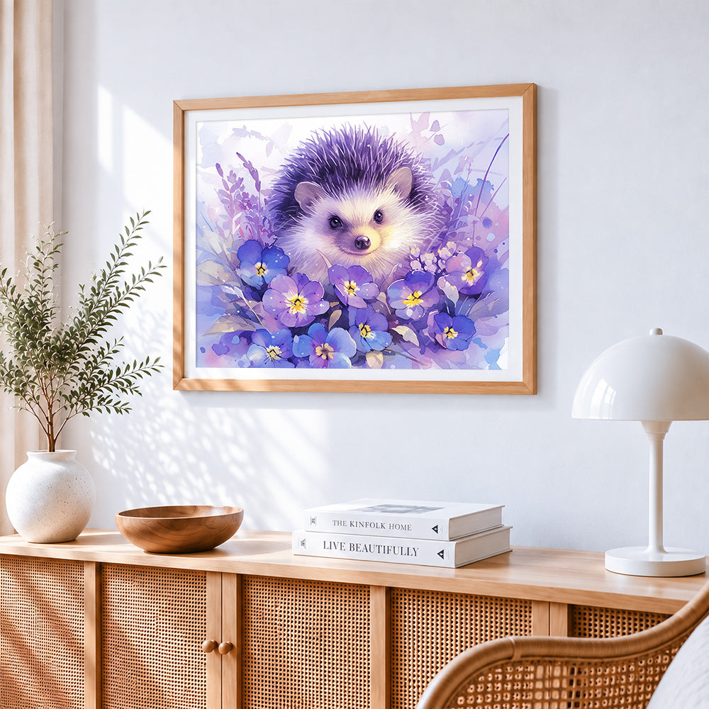 Watercolour hedgehog with purple flowers cross stitch artwork displayed on wall as home decor