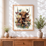 Finished watercolour highland cow family and butterflies cross stitch artwork displayed
