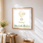 Watercolour hot air balloon cross stitch artwork displayed on wall as home decor