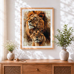 Finished watercolour lion and lioness portrait cross stitch artwork displayed