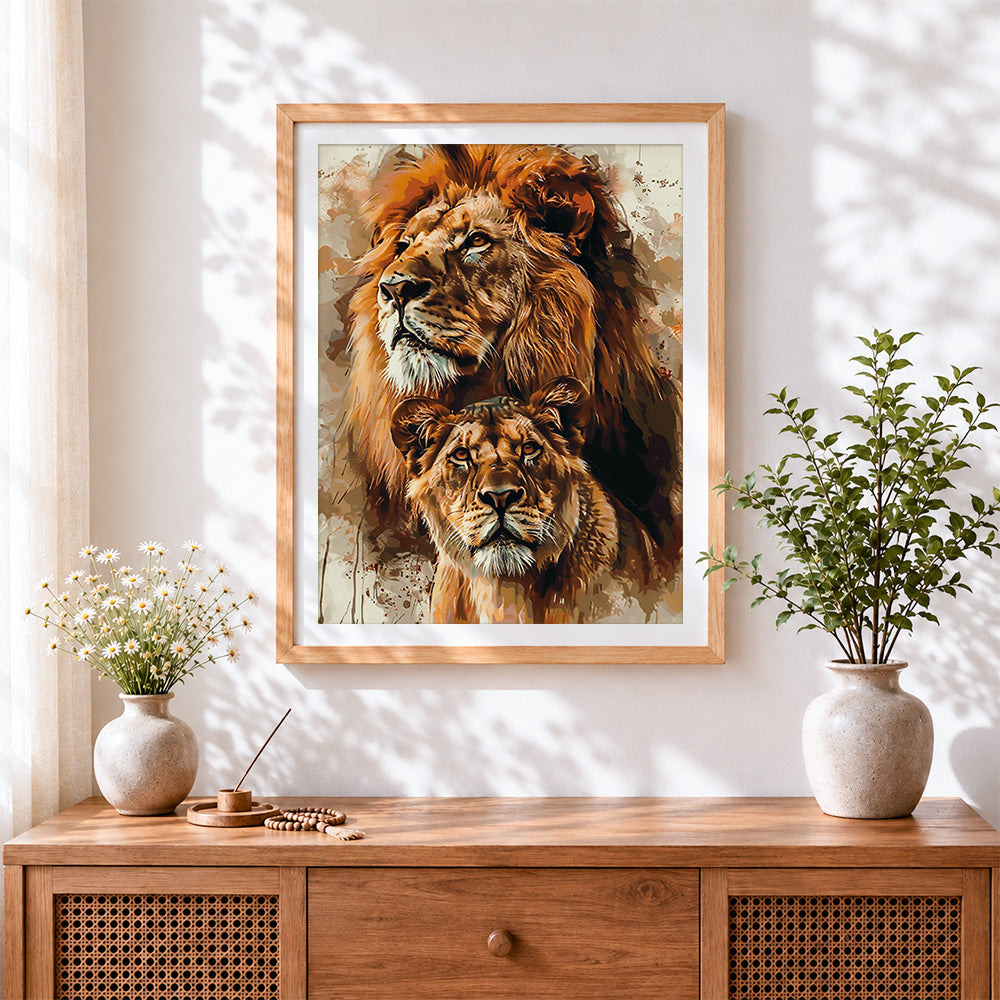 Finished watercolour lion and lioness portrait cross stitch artwork displayed