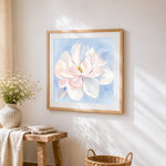 Watercolour magnolia flower cross stitch artwork displayed on wall as home decor