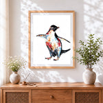 Finished watercolour penguin cross stitch artwork displayed
