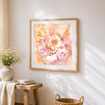 Watercolour pink roses and butterfly cross stitch artwork displayed on wall as home decor
