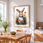 Watercolour rabbit in a wildflower meadow cross stitch artwork displayed on wall as home decor