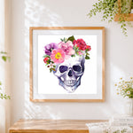 Finished watercolour skull with floral crown cross stitch artwork displayed