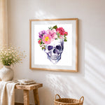 Watercolour skull with floral crown cross stitch artwork displayed on wall as home decor