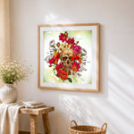 Watercolour skull with vibrant flowers cross stitch artwork displayed on wall as home decor