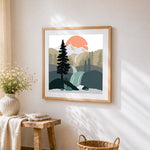 Waterfall and pine trees landscape cross stitch artwork displayed on wall as home decor