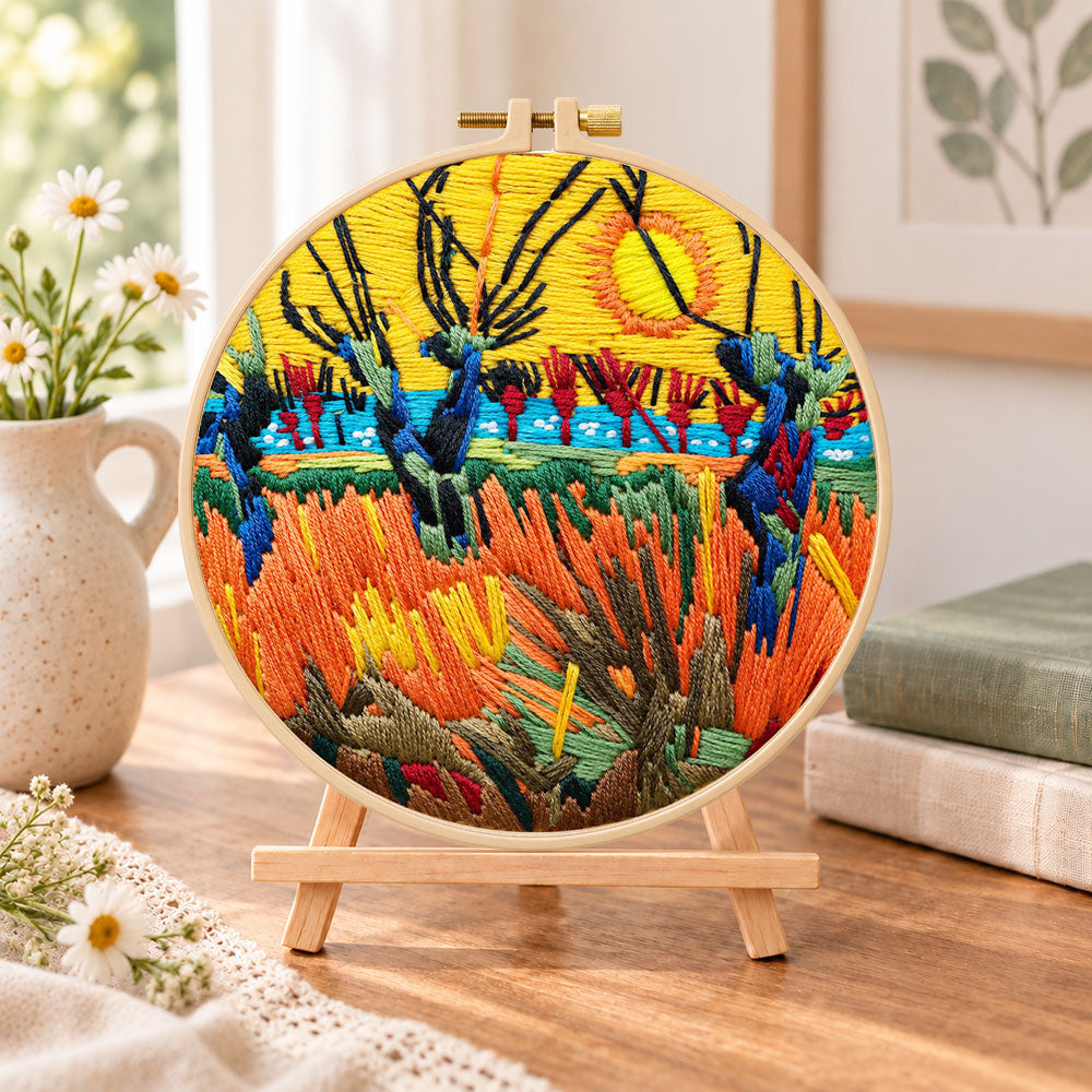 Wetland sunset scenery embroidery kit finished hoop displayed on a wooden stand as cozy tabletop decor