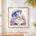 Finished whimsical bunny in a lace dress cross stitch artwork displayed
