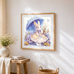 Whimsical bunny in a lace dress cross stitch artwork displayed on wall as home decor