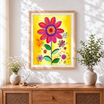 Finished whimsical cartoon flower cross stitch artwork displayed
