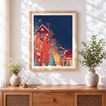 Finished whimsical colourful christmas village cross stitch artwork displayed