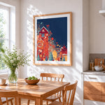 Whimsical colourful christmas village cross stitch artwork displayed on wall as home decor