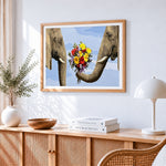 Whimsical elephants holding flowers cross stitch artwork displayed on wall as home decor
