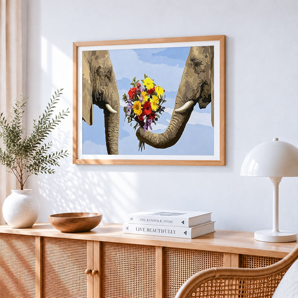 Whimsical elephants holding flowers cross stitch artwork displayed on wall as home decor