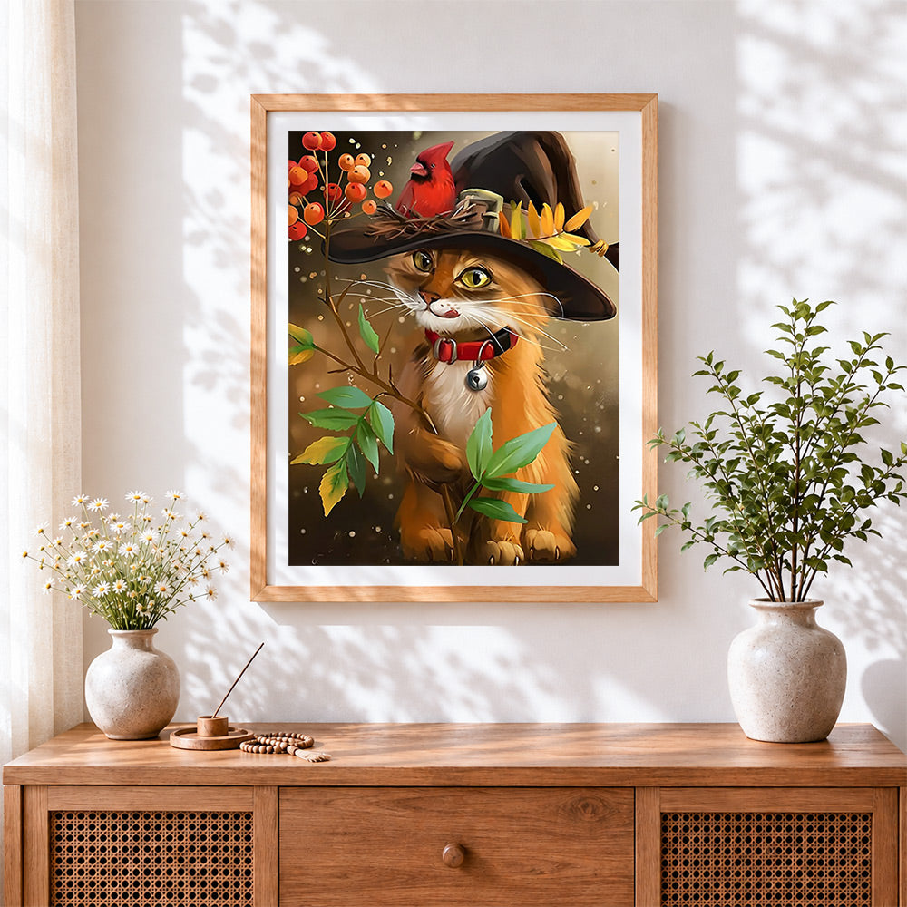 Finished whimsical orange cat in witch hat cross stitch artwork displayed