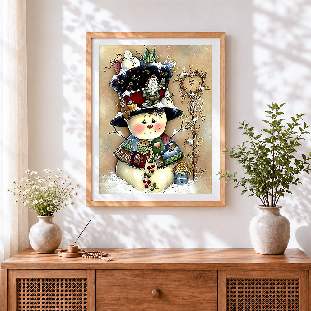 Finished whimsical patchwork snowman with top hat cross stitch artwork displayed