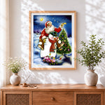 Finished whimsical santa and snowman cross stitch artwork displayed