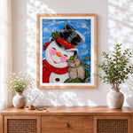 Finished whimsical snowman and owl in the snow cross stitch artwork displayed
