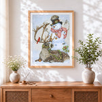 Finished whimsical snowman and reindeer cross stitch artwork displayed