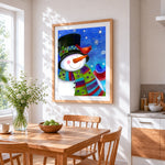 Whimsical snowman and winter birds cross stitch artwork displayed on wall as home decor