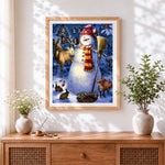 Finished whimsical snowman and woodland animals cross stitch artwork displayed