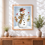 Finished whimsical snowman with hanging birdhouses cross stitch artwork displayed
