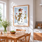 Whimsical snowman with hanging birdhouses cross stitch artwork displayed on wall as home decor
