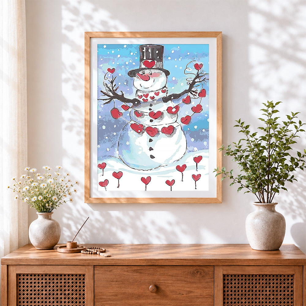 Finished whimsical snowman with heart decorations cross stitch artwork displayed