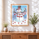 Finished whimsical snowman with heart decorations cross stitch artwork displayed