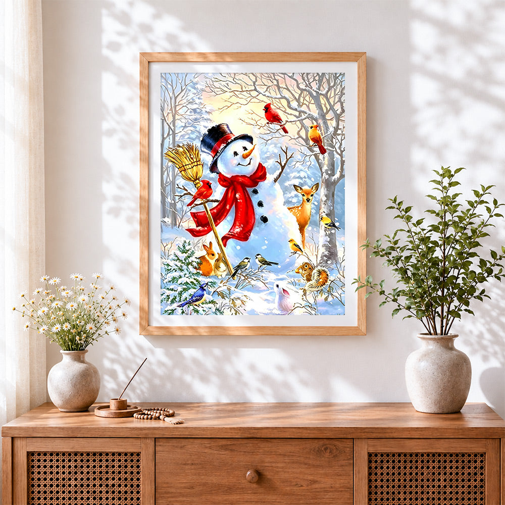 Finished whimsical snowman with woodland birds cross stitch artwork displayed
