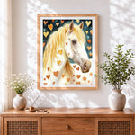 Finished whimsical white horse and hearts cross stitch artwork displayed