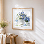 White and blue floral still life cross stitch artwork displayed on wall as home decor