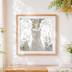 Finished white angel statue cross stitch artwork displayed