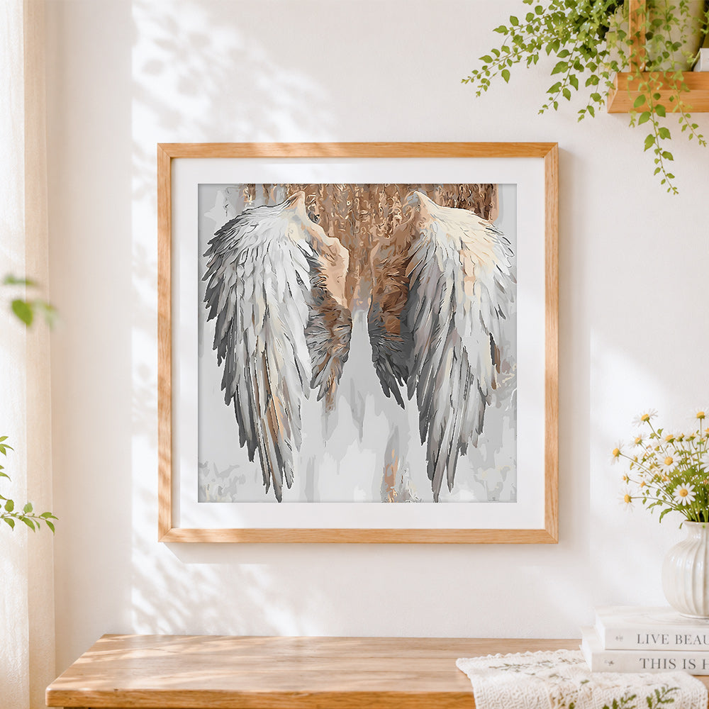 Finished white angel wings cross stitch artwork displayed