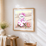White cat with heart envelope in teacup cross stitch artwork displayed on wall as home decor
