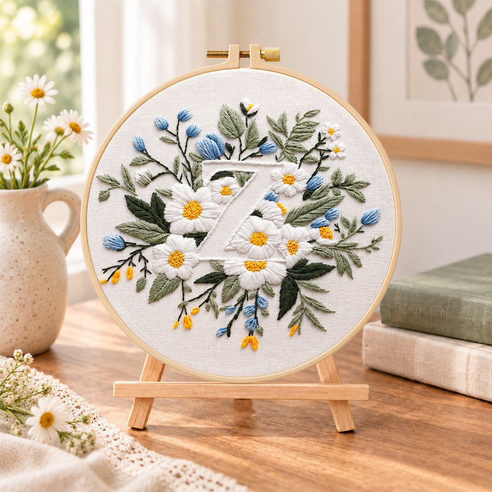 White daisies and letter z embroidery kit finished hoop displayed on a wooden stand as cosy tabletop decor
